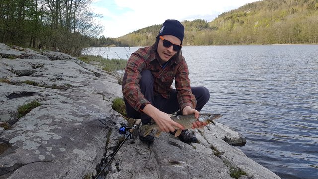 The proud fisherman displays his catch.