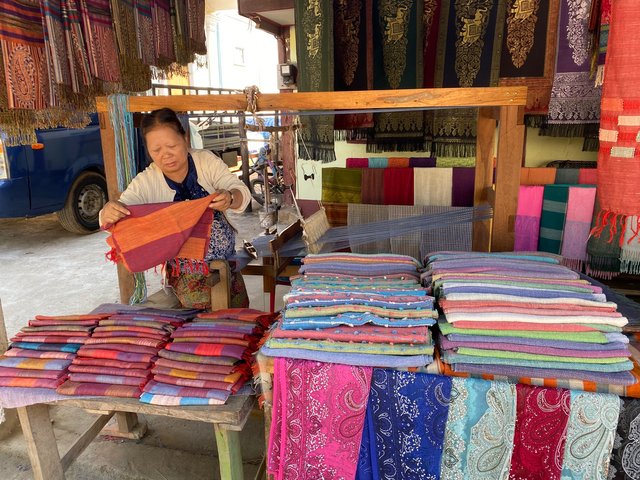 An elderly woman selling her products.