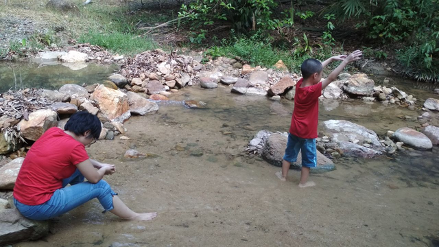 The boy actually chasing for a frog