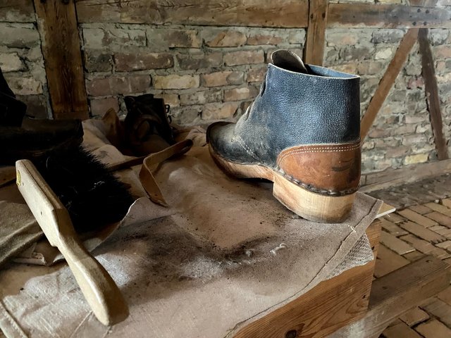 No easy job keeping the kiln going wearing these wooden-soled boots