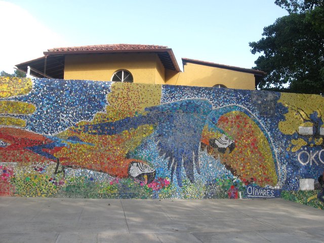 The beautiful mural with macaws among sunflowers