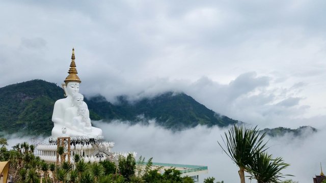 Look at this photo above. All the other photos show perfect skies. The weather as we were approaching the temple site was cloudy and wet. It had rained earlier and the mountains still had the clouds in the hills. It gave the photo a most memorable look. You can now see how large the stacked Buddha figure is compare to all around. This is one of my favorite photos from my trip.