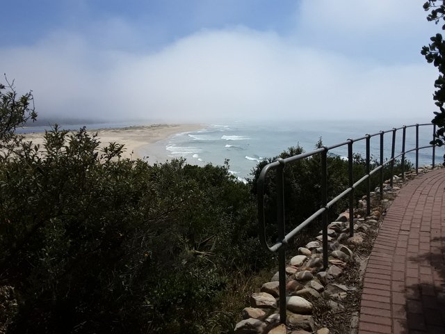 Misty curtains rolling back on Lookout beach as the sun rises higher