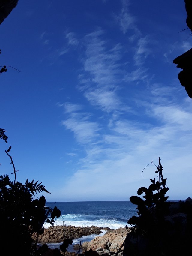 Trying to get the whole picture into the camera frame showing the small cave mouth and view