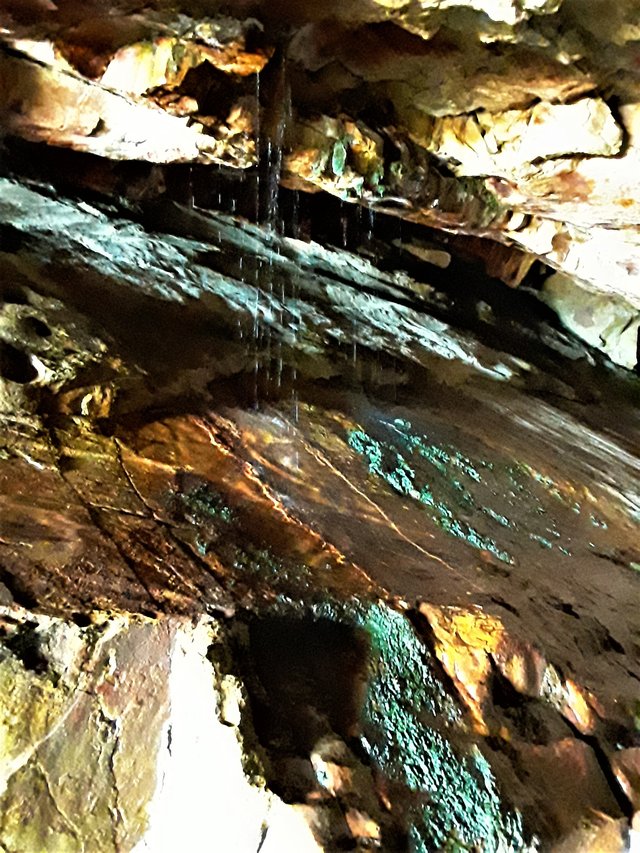 Epic scene of spring water pouring from the cave roof