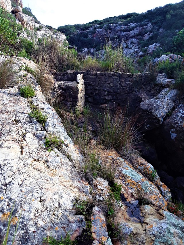 manmade rock wall in the river gorge to channel the fresh water just before it enters the pool