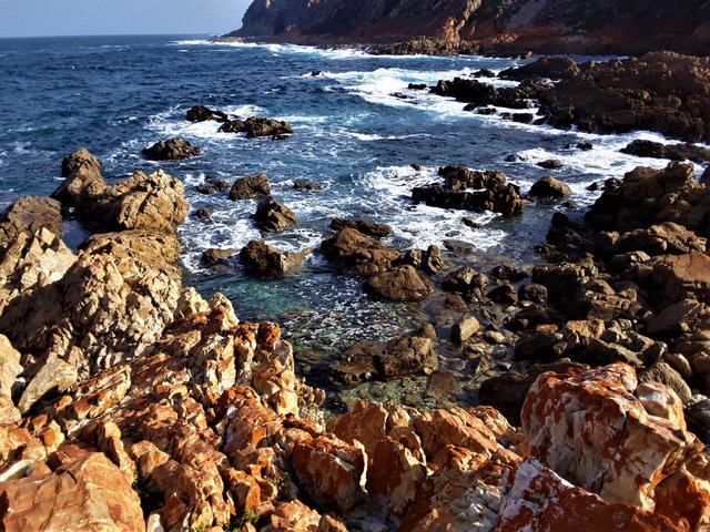 Stumbling upon the bright orange rocks of this little bay brought a blissful mood to the experience