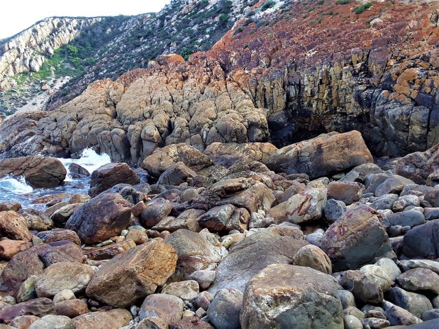 Here the bright ochre pigment is particularly noticeable on the cliff slope. And you can see why so few people come here - it’s difficult to access