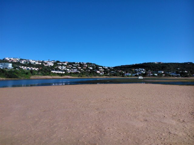 Low tide on the lagoon at Lookout beach with the town of Plettenberg Bay in the background
