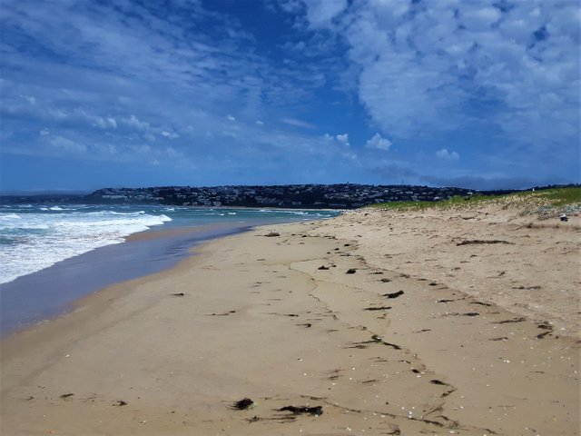 Facing west, with Indian ocean meeting the African coastline at the Garden Route town of Plettenberg Bay, seen in the background.