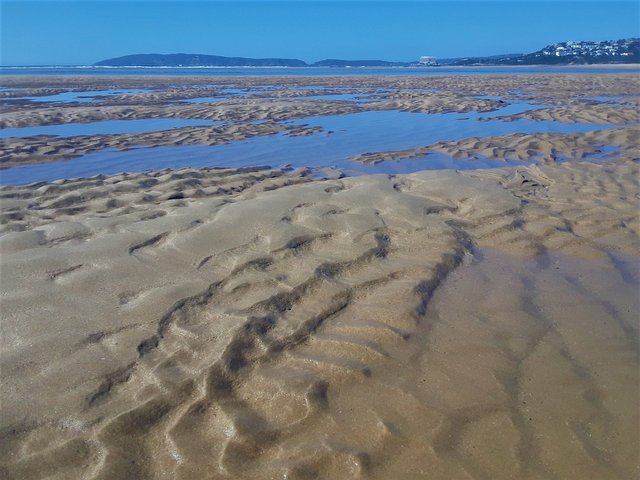 Robberg peninsula in the distance, with the town on the right - a holiday paradise