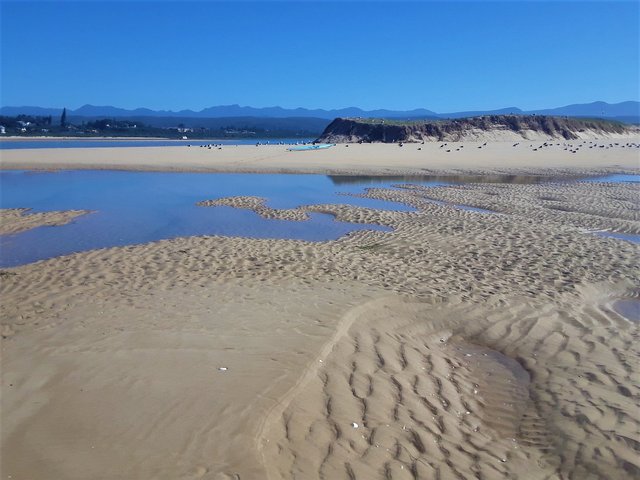 Puddles and reflections on the water at very low tide