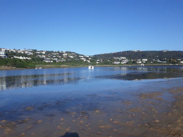 Boats anchor on the lagoon waiting for the tide to rise and lift them once more