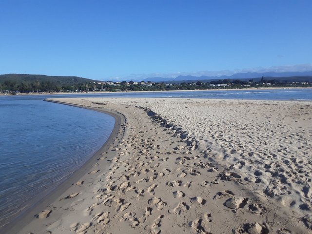 The mouth of the lagoon to the right with sea behind me