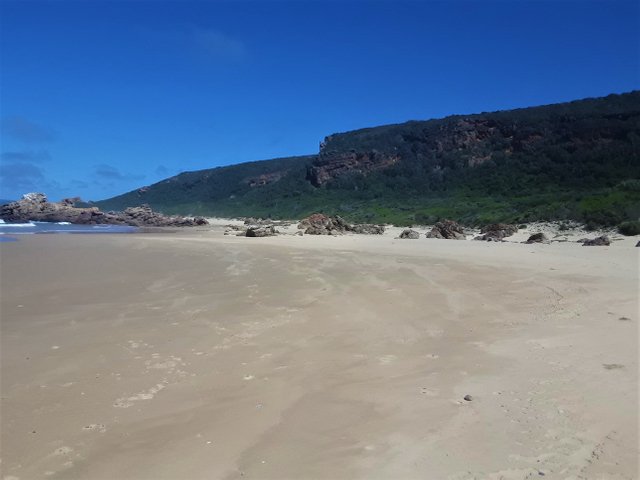 Epic African shoreline, with rugged hillside covered by thick bush and shrub
