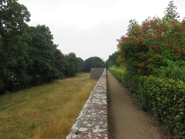 The city wall, some of which is Roman. The river Lavant flows beneath the trees to the left.