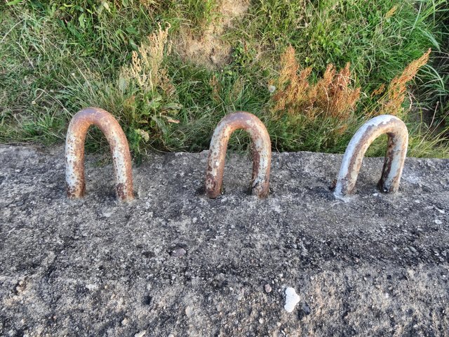 Rusty metal things, the salty air bites the concrete