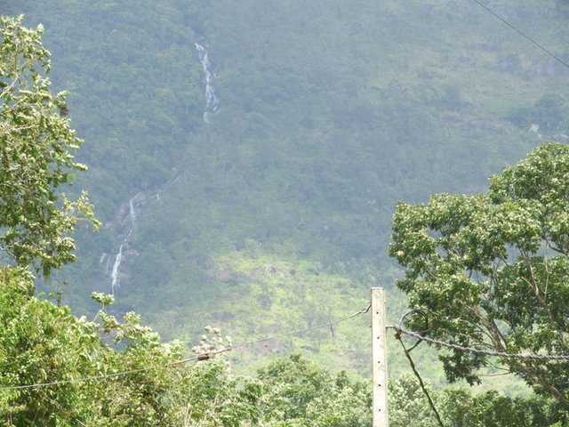 Find the white shining, beautiful Rakwana Galdola Falls in Sri Lanka.