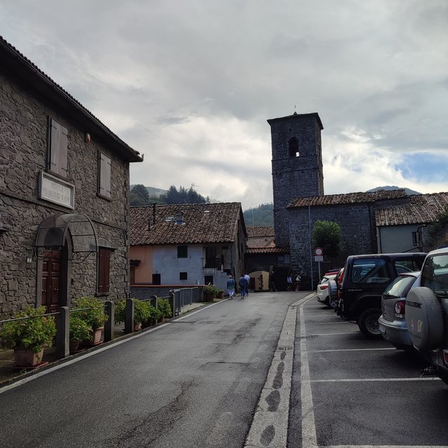 This is main street with the main tower part of the only church of the village.