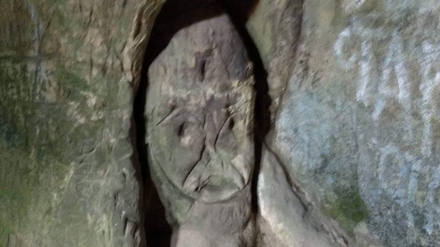 A mysterious face carved from stone in the premises of the monastery church