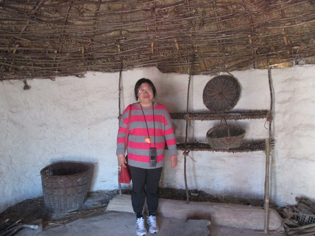 My wife inside one of the huts.