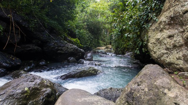 There were a lot of volcanic rocks at the river where the waterfall is.