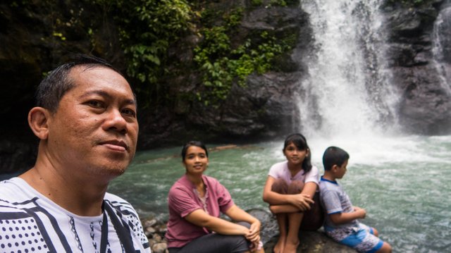 Posing before the waterfall.