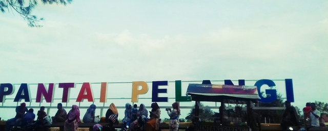 Pelangi Beach Photo Pictures, Seen some mothers and their families are sitting relaxing while enjoying the panoramic beauty of the sea on the coast and the Rainbow Park.