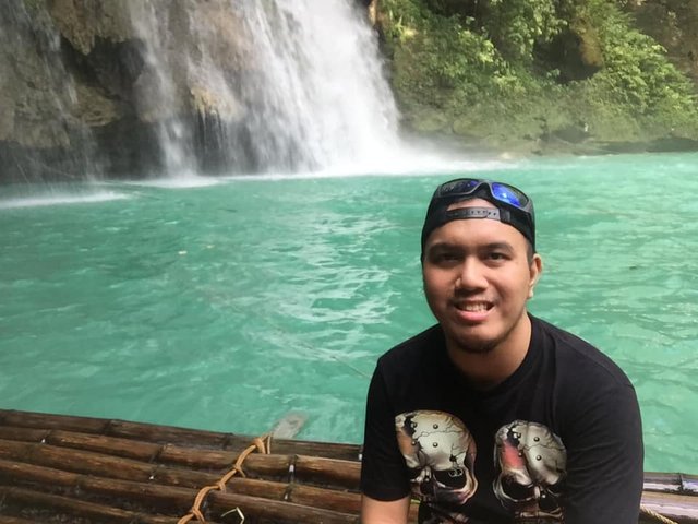 Riding a wooden raft near the falls