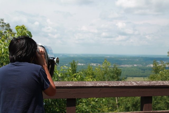 Magnus looks through binoculars on the observation tower