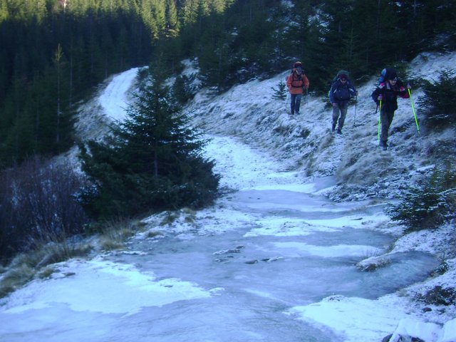 We hike along the bank of the frozen stream