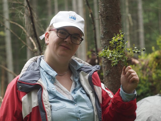 My wife with a sprig of blueberry bush