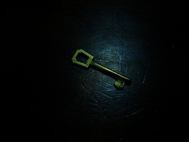 Picture of golden key in the dark