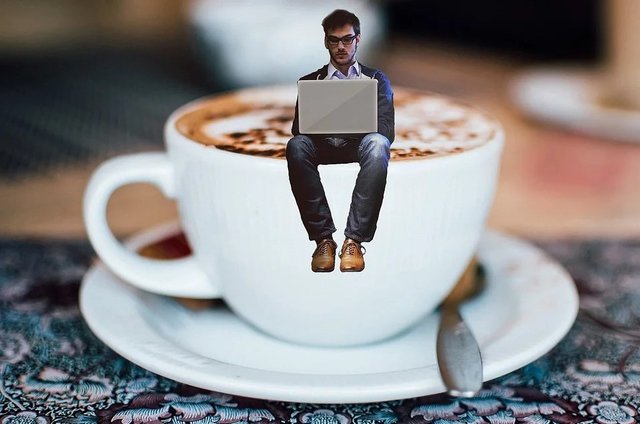 Writer sitting on a coffee cup