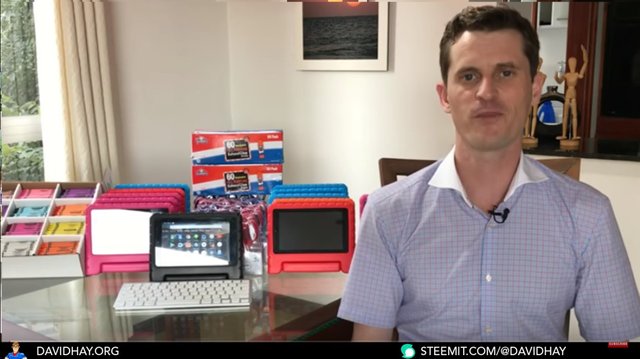 David Hay showing his first pre-configured tablets and also showing some other needed school supplies