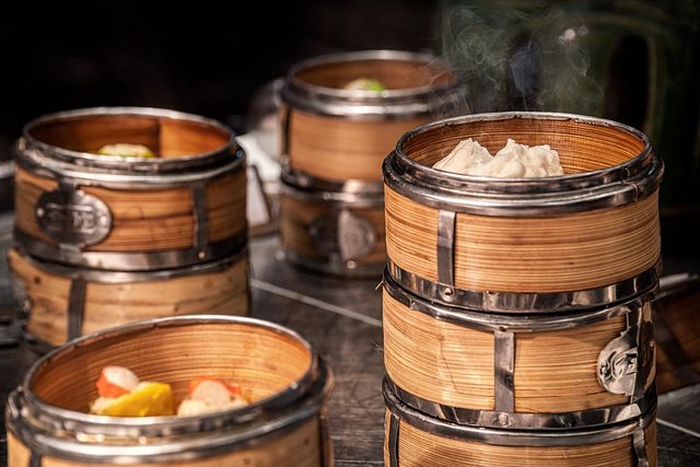 Steaming dumplings in bamboo steamers