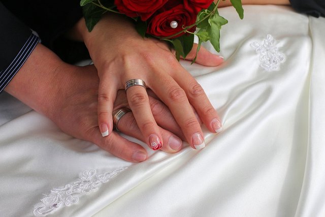 Wedding bands, hands together