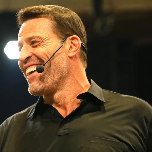 Tony Robbins, the iconic motivational speaker, speaking passionately on stage