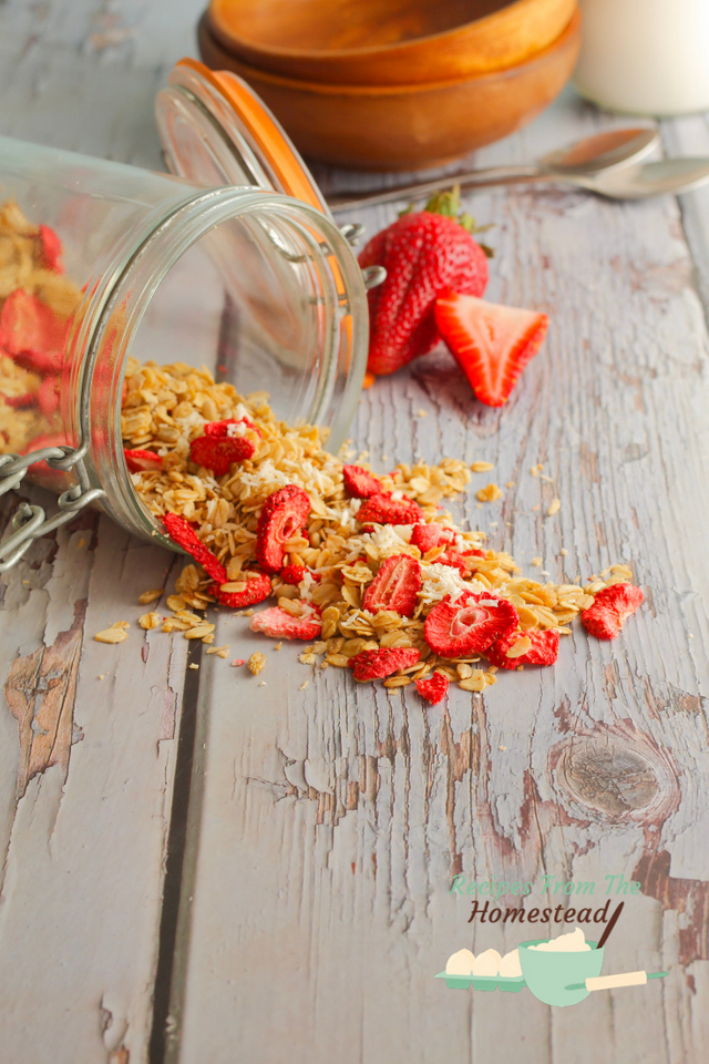 strawberry coconut granola spilling out of jar
