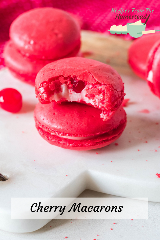 cherry macaron stacked with one bite taken out