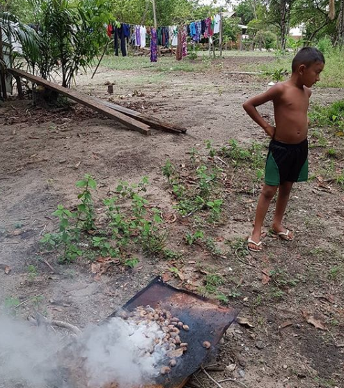 One of the children keeps an close eye on the process