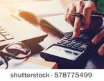 stock-photo-close-up-woman-doing-finance-at-home-office-with-calculate-expenses-578775499.jpg