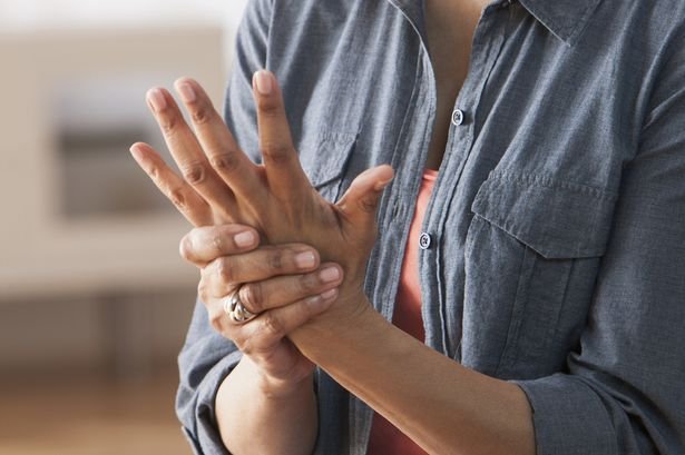 Older-Black-woman-rubbing-her-hands--Arthritis.jpg