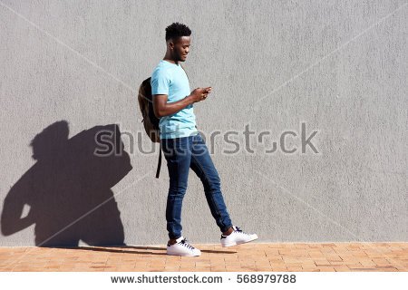 stock-photo-full-length-portrait-of-college-student-walking-with-bag-and-mobile-phone-568979788.jpg