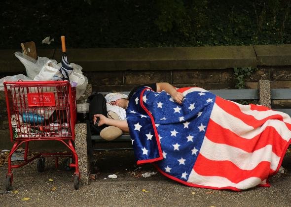 180216257-homeless-man-sleeps-under-an-american-flag-blanket-on-a.jpg.CROP.promo-mediumlarge.jpg