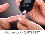 stock-photo-close-up-of-a-doctor-checking-patient-s-sugar-level-with-glucometer-519782257.jpg