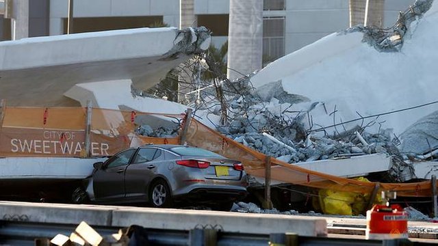 damaged-car-is-seen-partially-stuck-under-a-collapsed-pedestrian-bridge-at-florida-international-university-in-miami-2.jpg