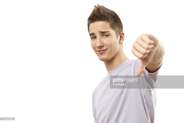 unhappy-teenage-boy-showing-thumbs-down-sign-picture-id186825498.jpeg