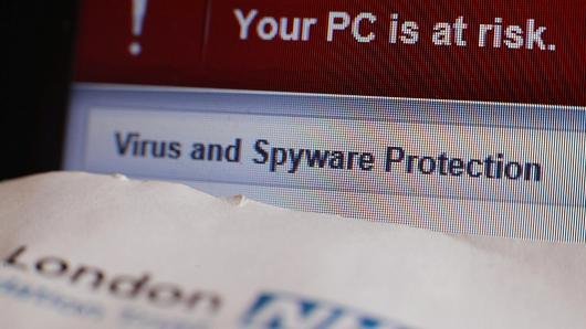 A patient appointment letter coming from a London NHS hospital, next to a virus as well as also spyware warning message on a laptop screen at a home in London, following a major cyber attack on NHS computer systems.