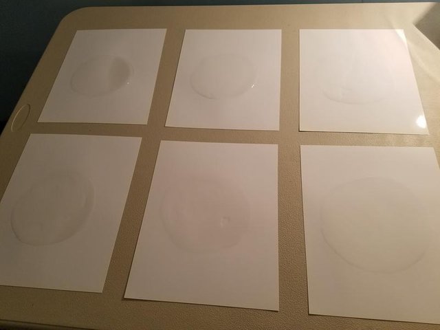 blobs of water on glossy paper